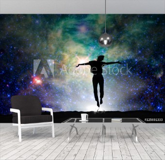 Picture of Silhouette of a woman jumping starry night background